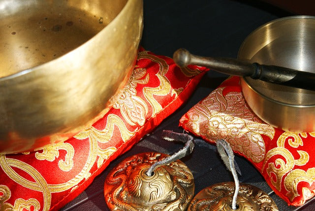 Singing Bowls on red pillows
