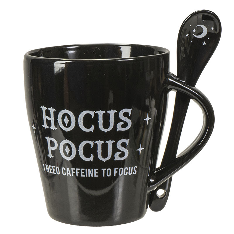 Black mug with 'Hocus Pocus' text and a spoon on a white background