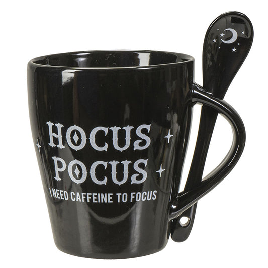 Black mug with 'Hocus Pocus' text and a spoon on a white background