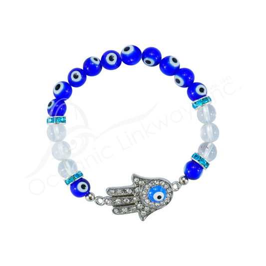 Bracelet with blue evil eye beads and silver Hamsa hand charm on a white background