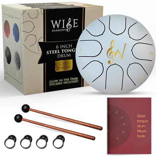 white tongue drum with mallets, book, and box