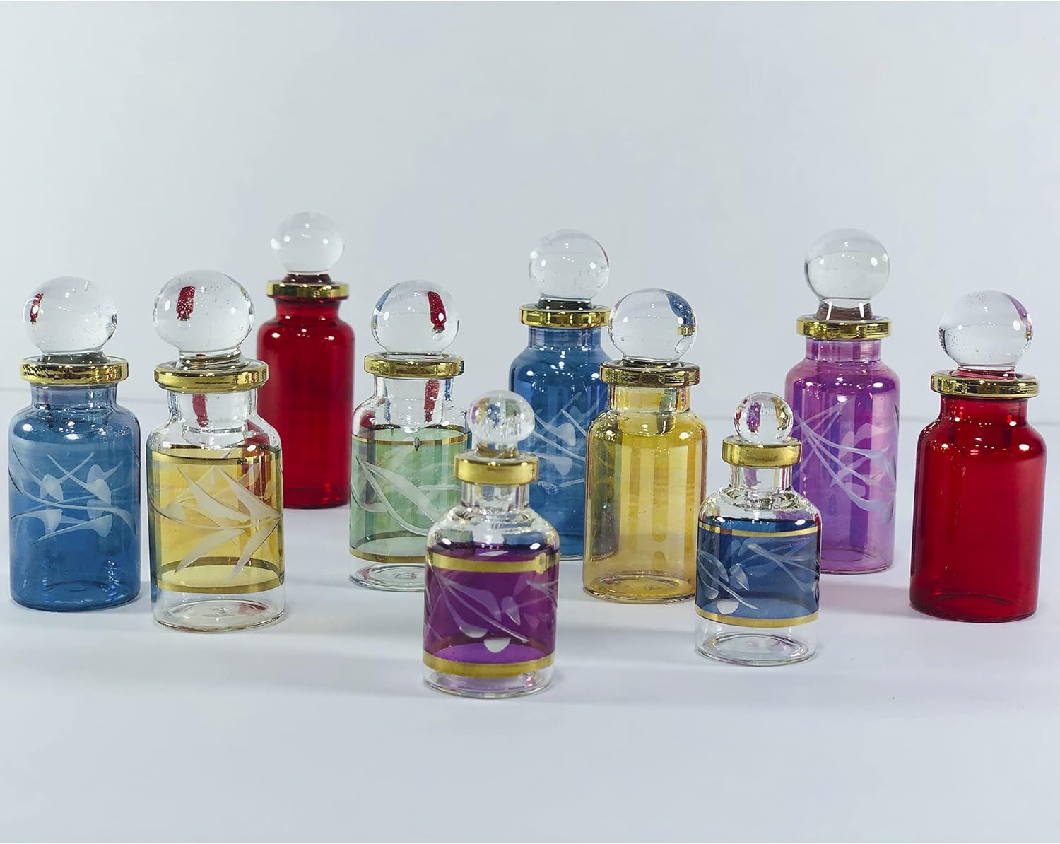 Set of colorful glass bottles with various designs on a white background