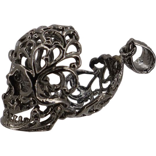 Decorative gunmetal skull with intricate design on a white background