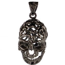 Decorative gunmetal skull with intricate design on a white background