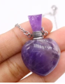 Purple glass bottle pendant with a chain on a white background