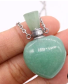 Heart-shaped green pendant with a silver chain on a white background