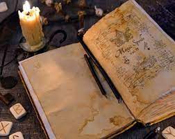 Open book with magical symbols, candles, and runes on a dark surface