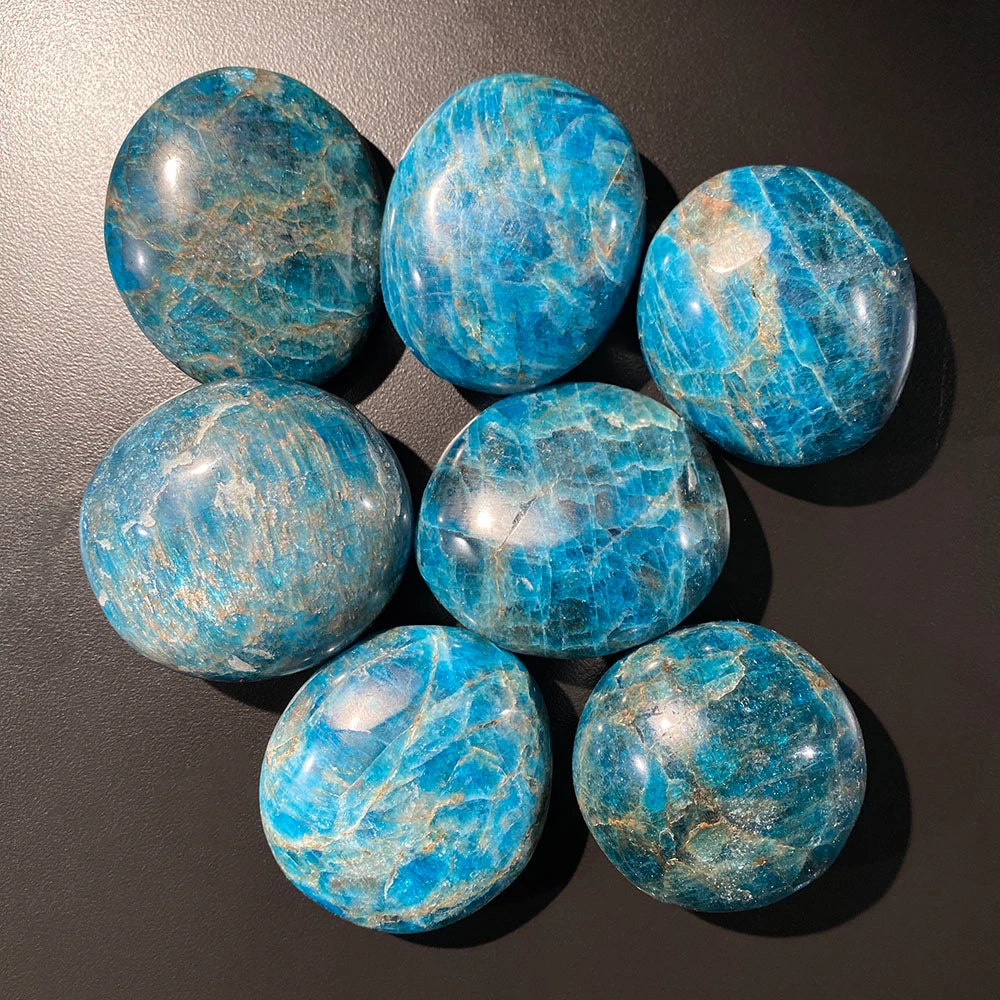 Blue marbled stones on a dark surface