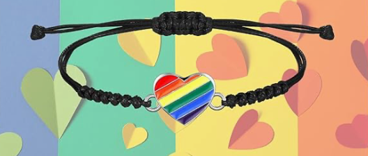 Black braided bracelet with a rainbow heart charm on a colorful background with heart shapes.
