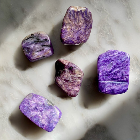 smooth, tumbled, rectangular stones, mostly dark purple with black, white, and silver swirls