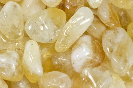 Around half inch yellow, orange, and white semi-translucent tumbled stones.