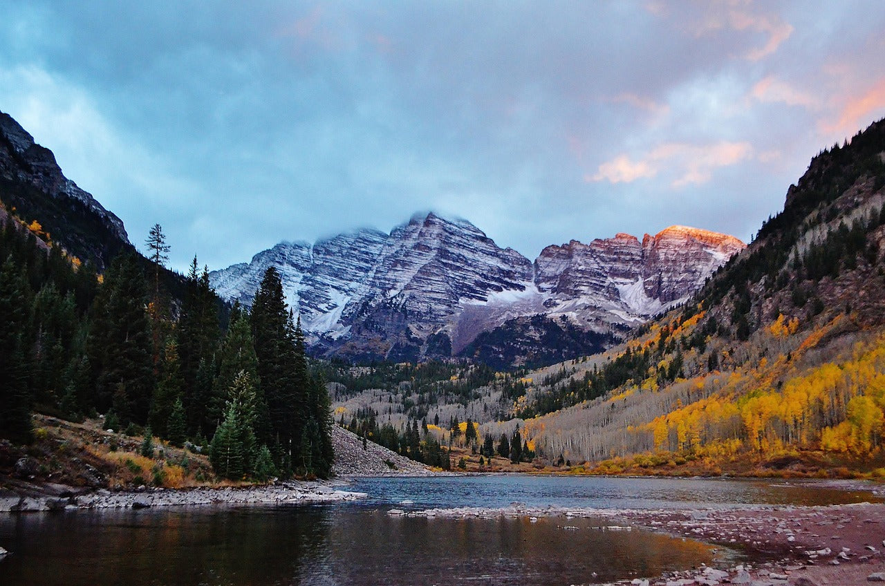 Colorado Mountain landscape with a lake and trees at sunset