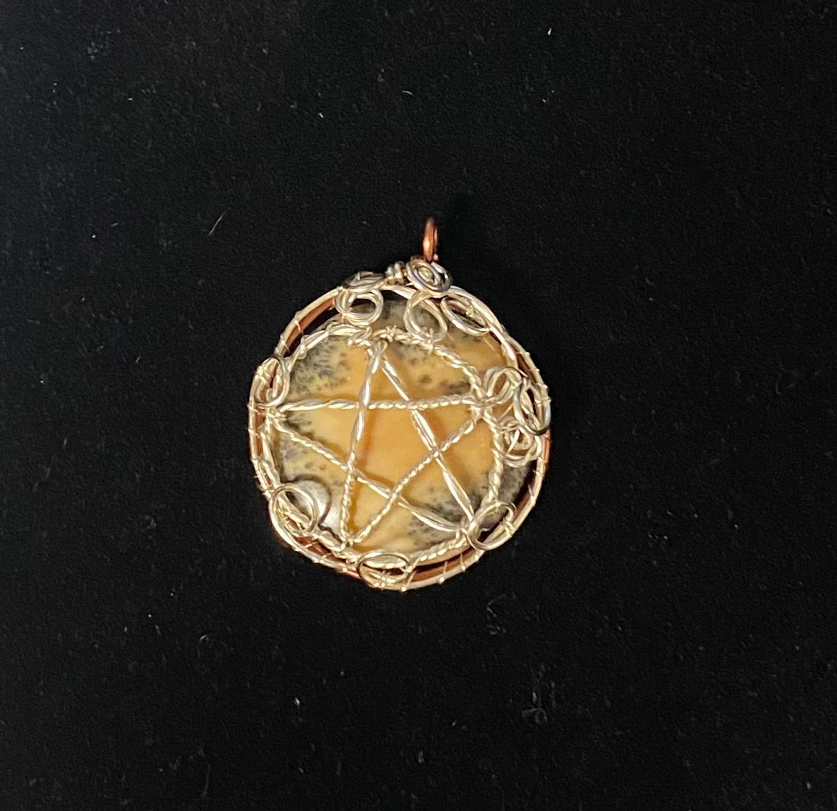 Dendritic Jasper Silver wrapped Pentacle on a black background