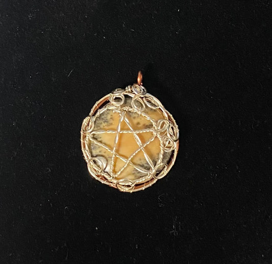 Dendritic Jasper Silver wrapped Pentacle on a black background