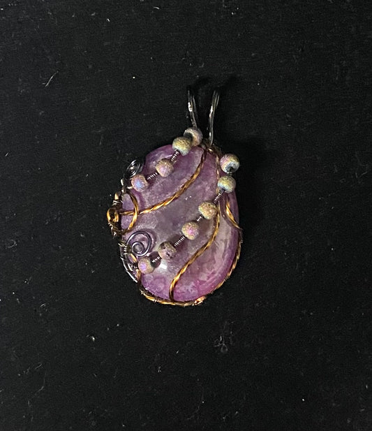Pendant Dragon Scale Crackle Quartz Wrapped with clay colored beads on a black background front