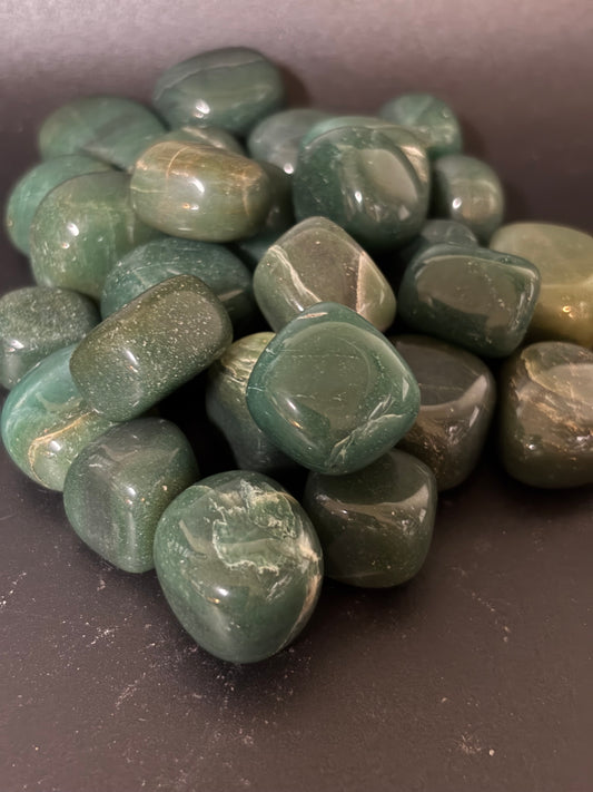 Collection of Jade stones on a dark surface