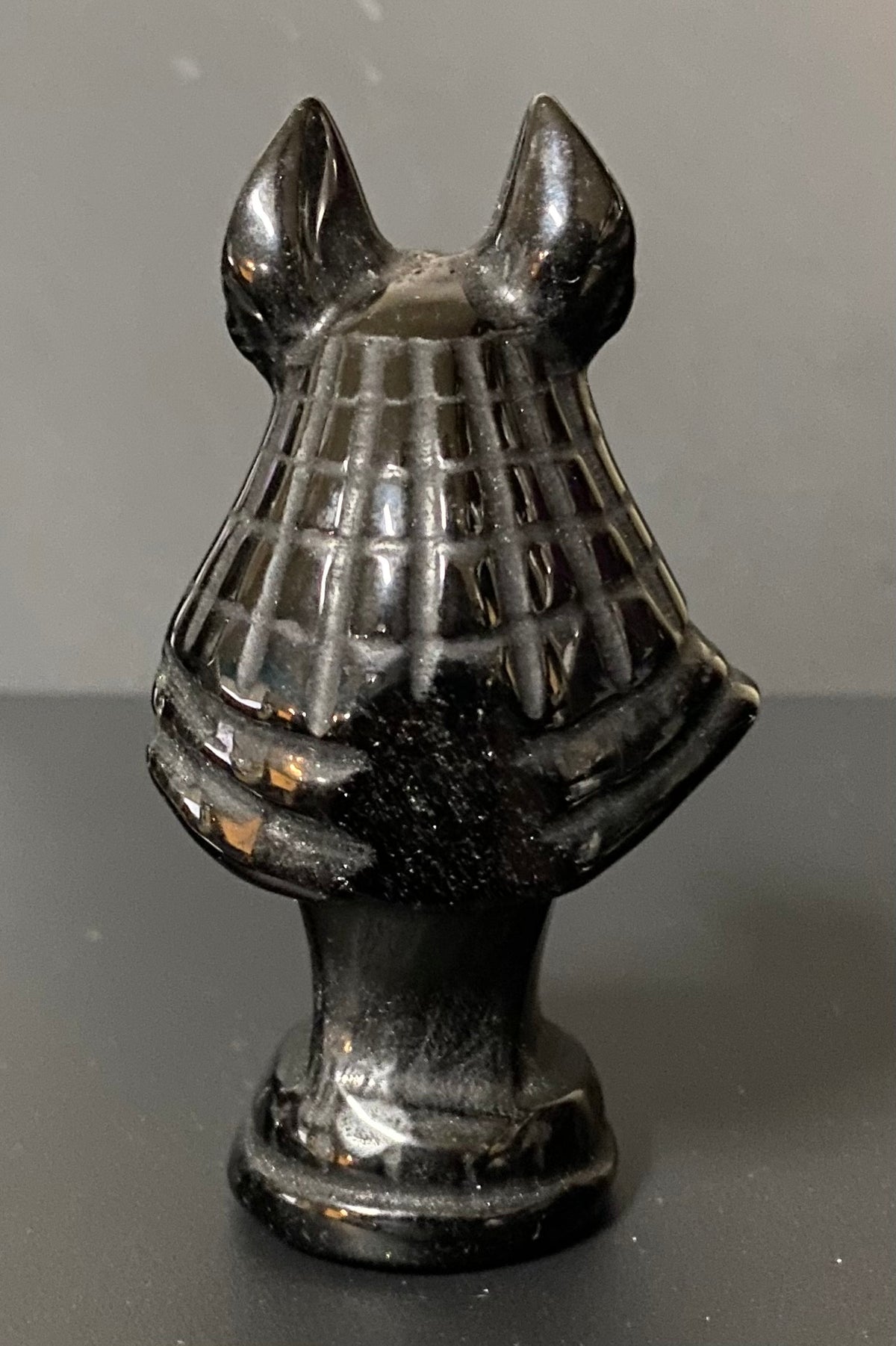 Obsidian Anubis Bust on a black background. back view
