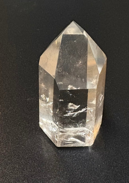 Polished clear quartz on black background
