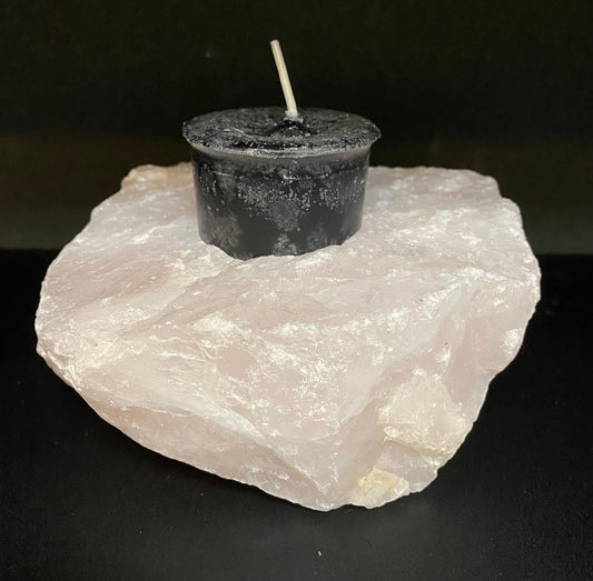Candle Holder Rose Quartz rough shaped displaying a black candle