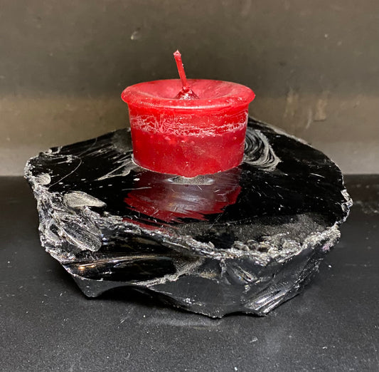 Candle Holder Obsidian rough shaped displaying a red candle
