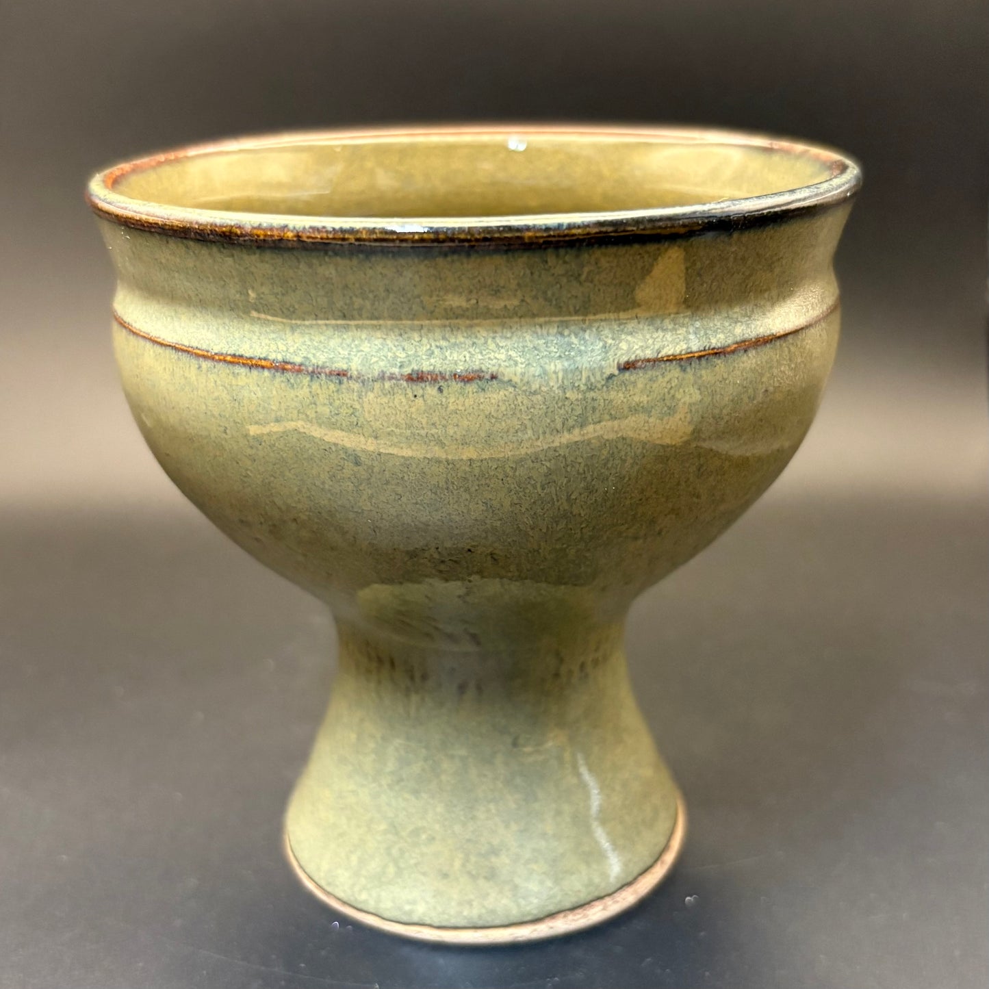 Sage Green ceramic pedestal bowl on grey background