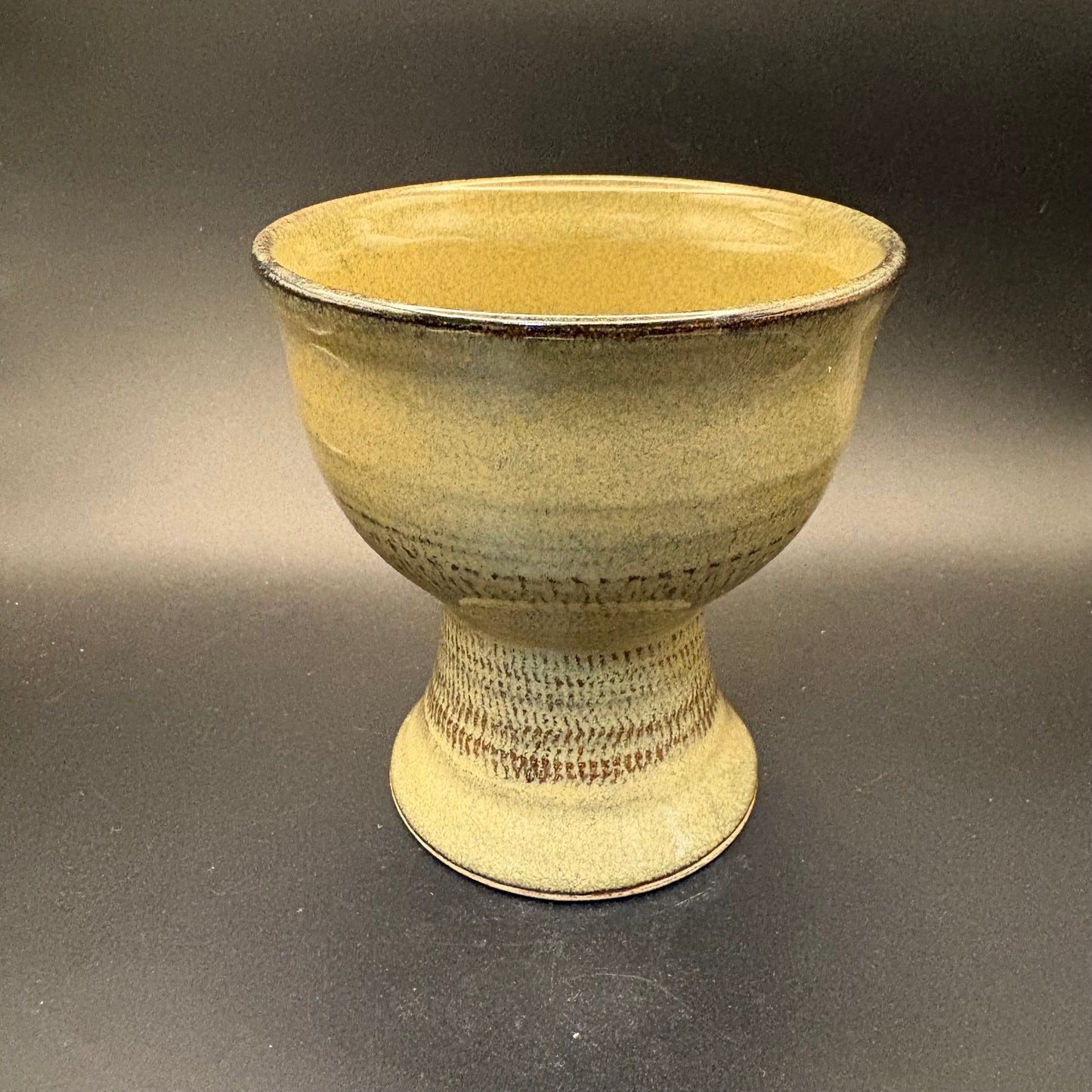 Sage Green ceramic pedestal bowl on grey background