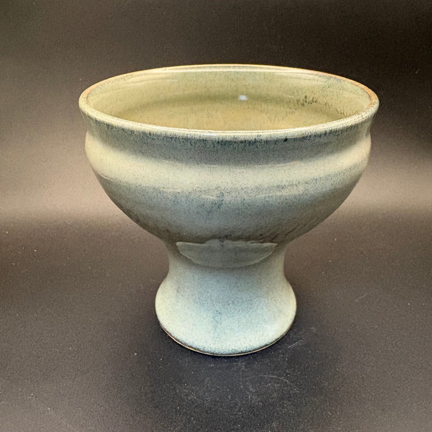 Grey-Blue ceramic pedestal bowl on grey background