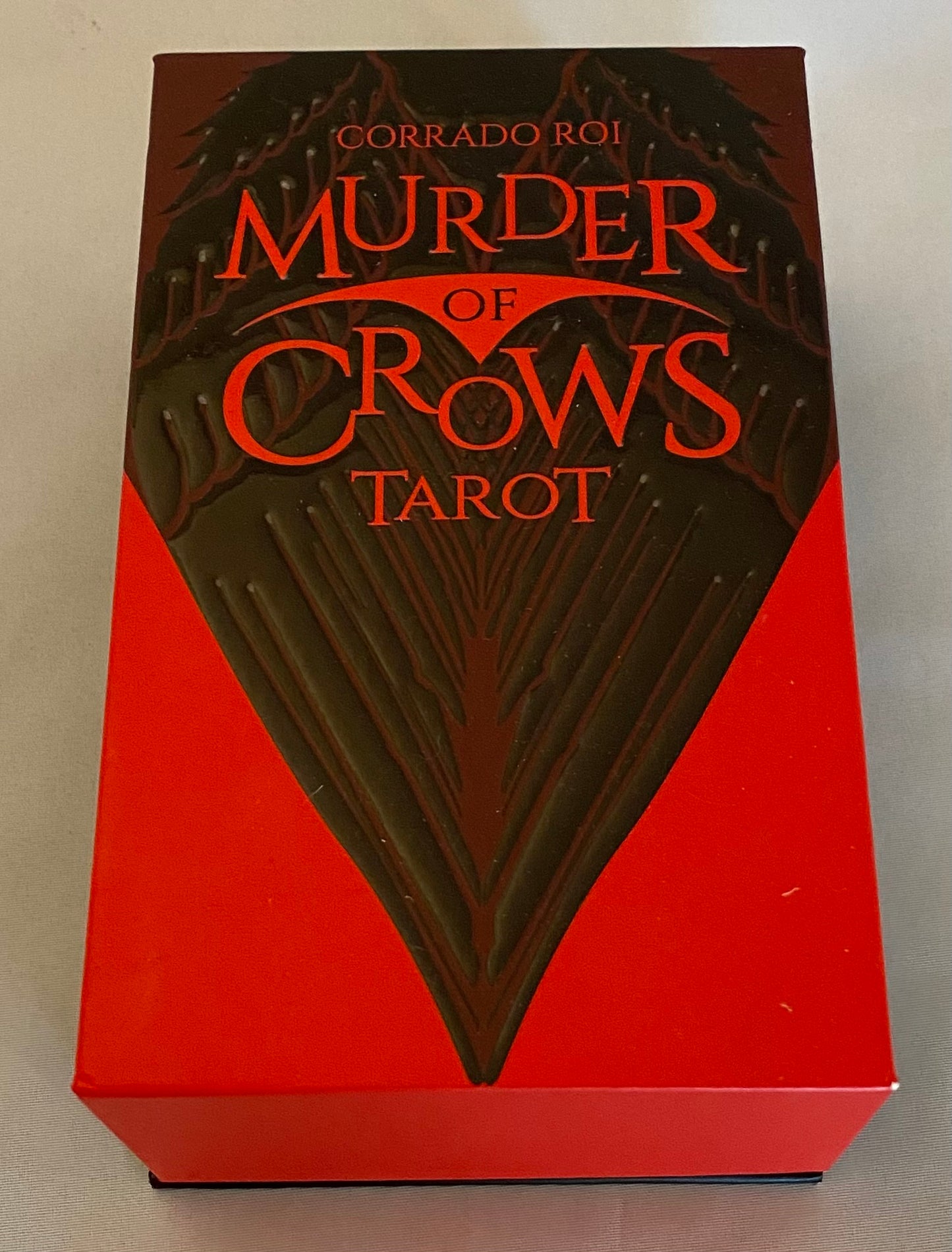 Tarot card box titled 'Murder of Crows Tarot' with red and black design.