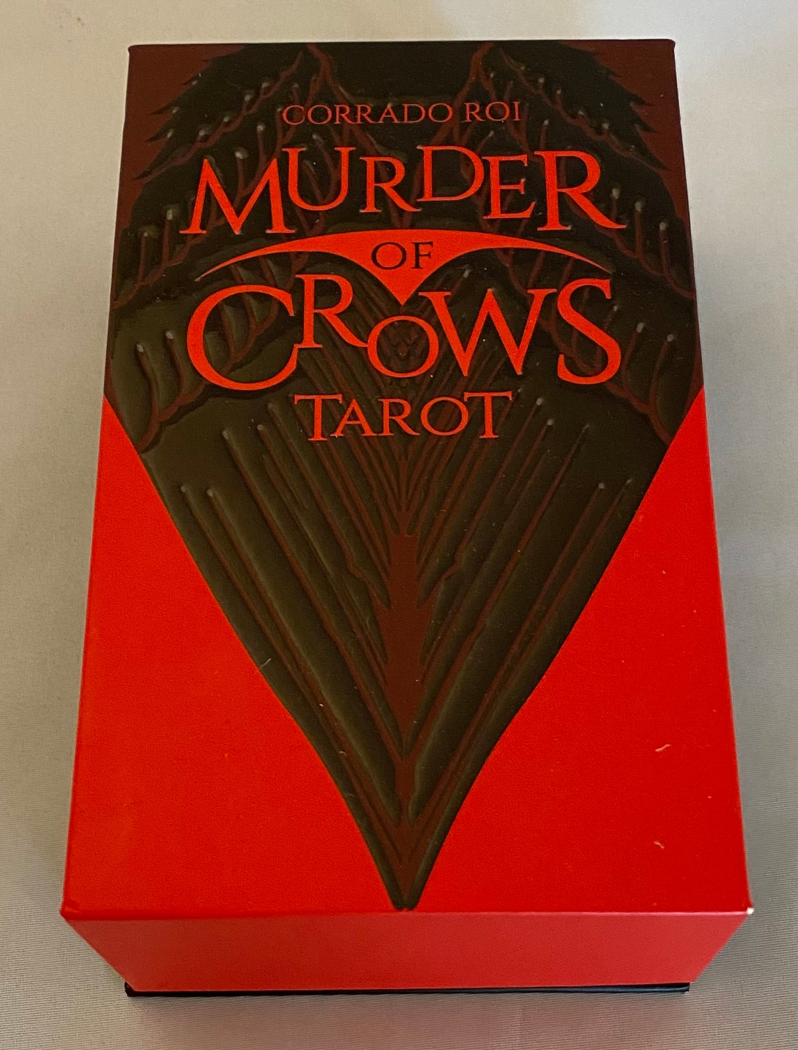Tarot card box titled 'Murder of Crows Tarot' with red and black design.