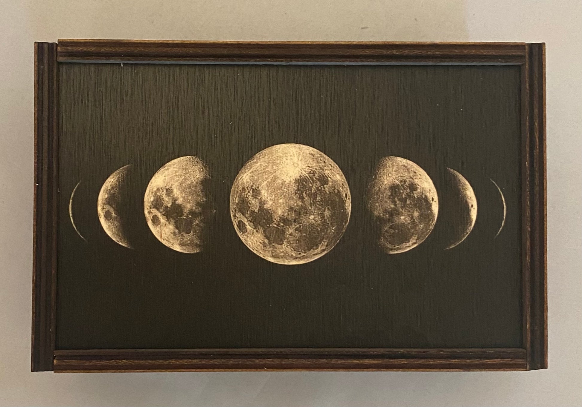 brown wooden box with moon images