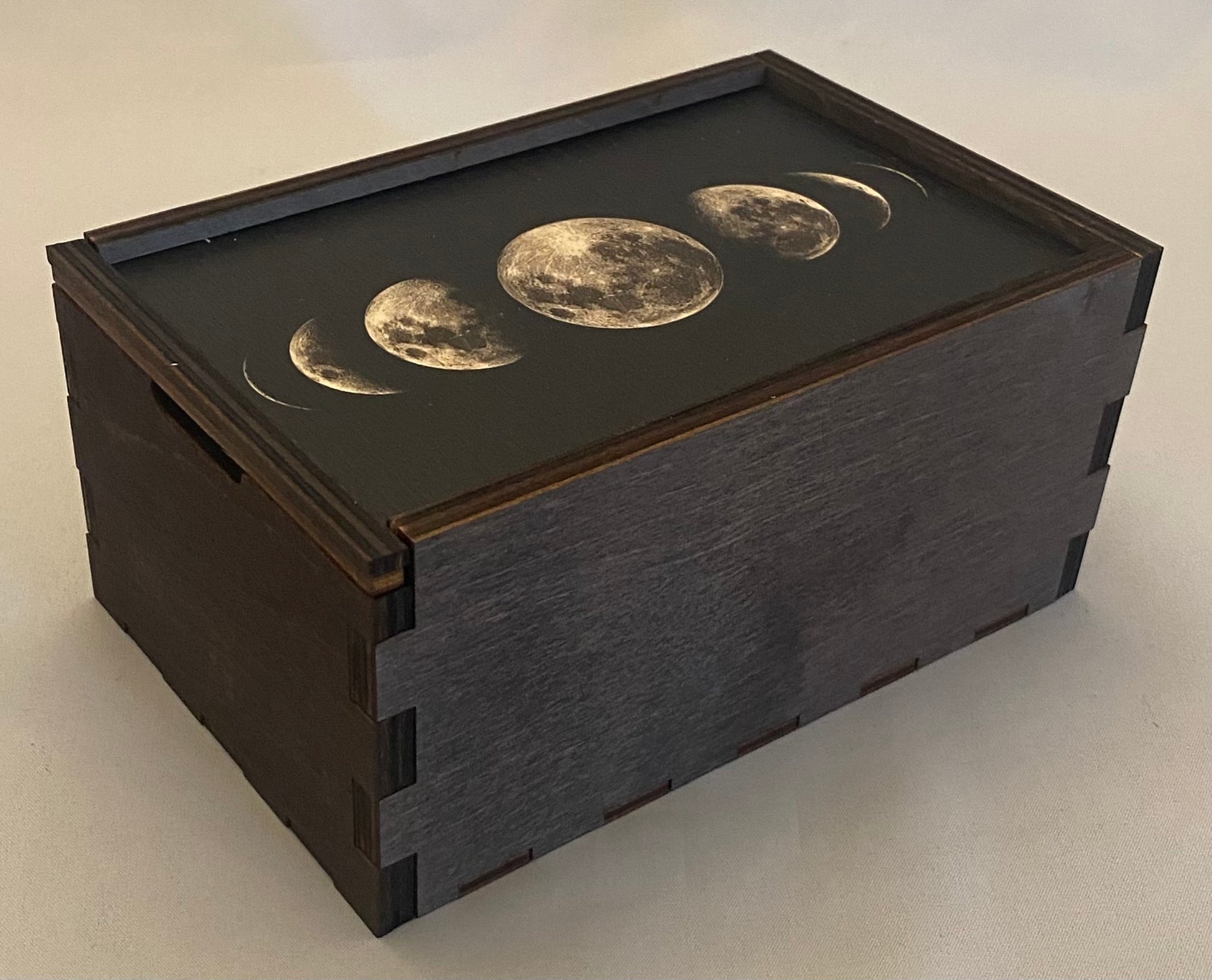 brown wooden box with moon images