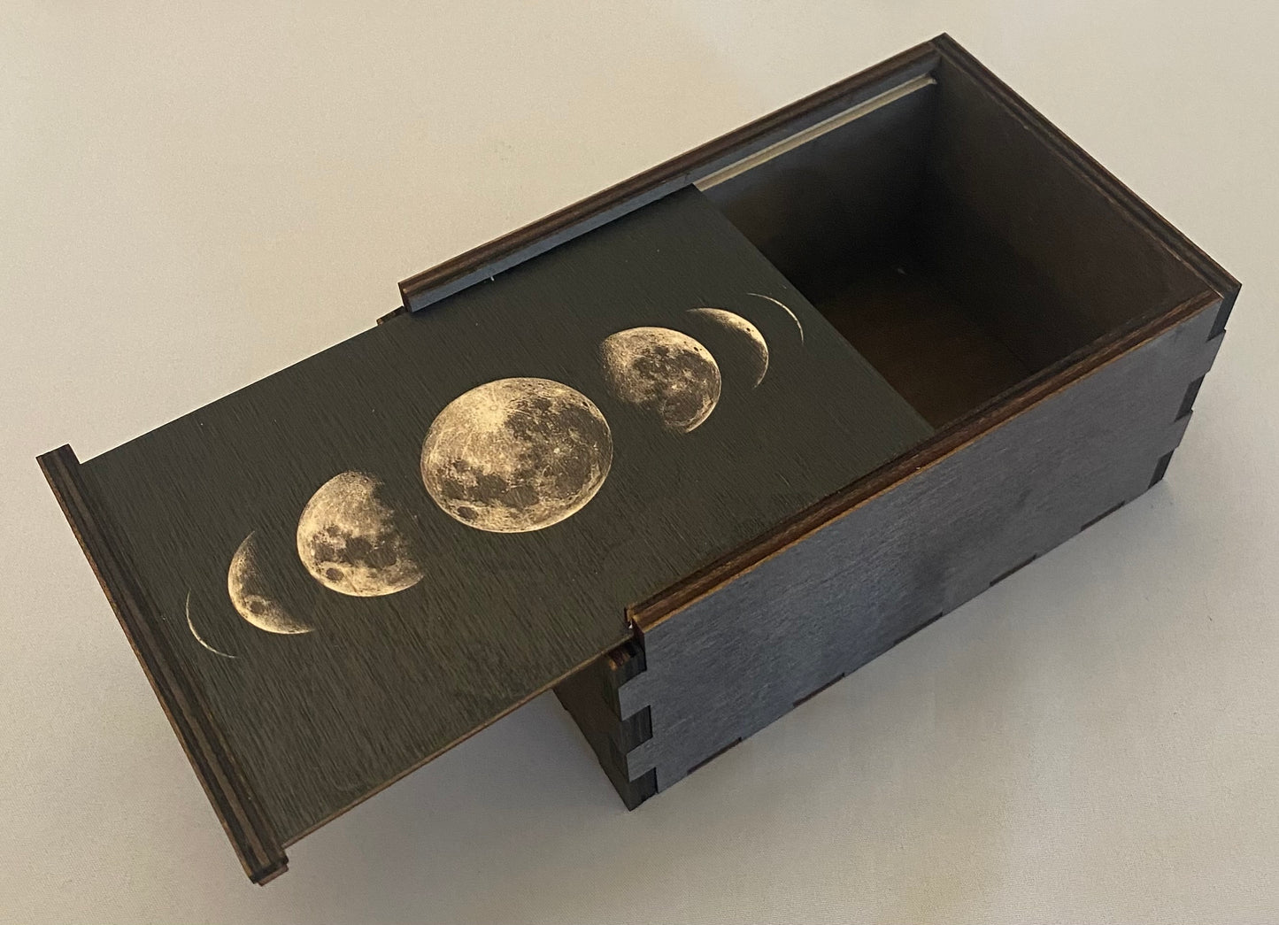 brown wooden box with moon images