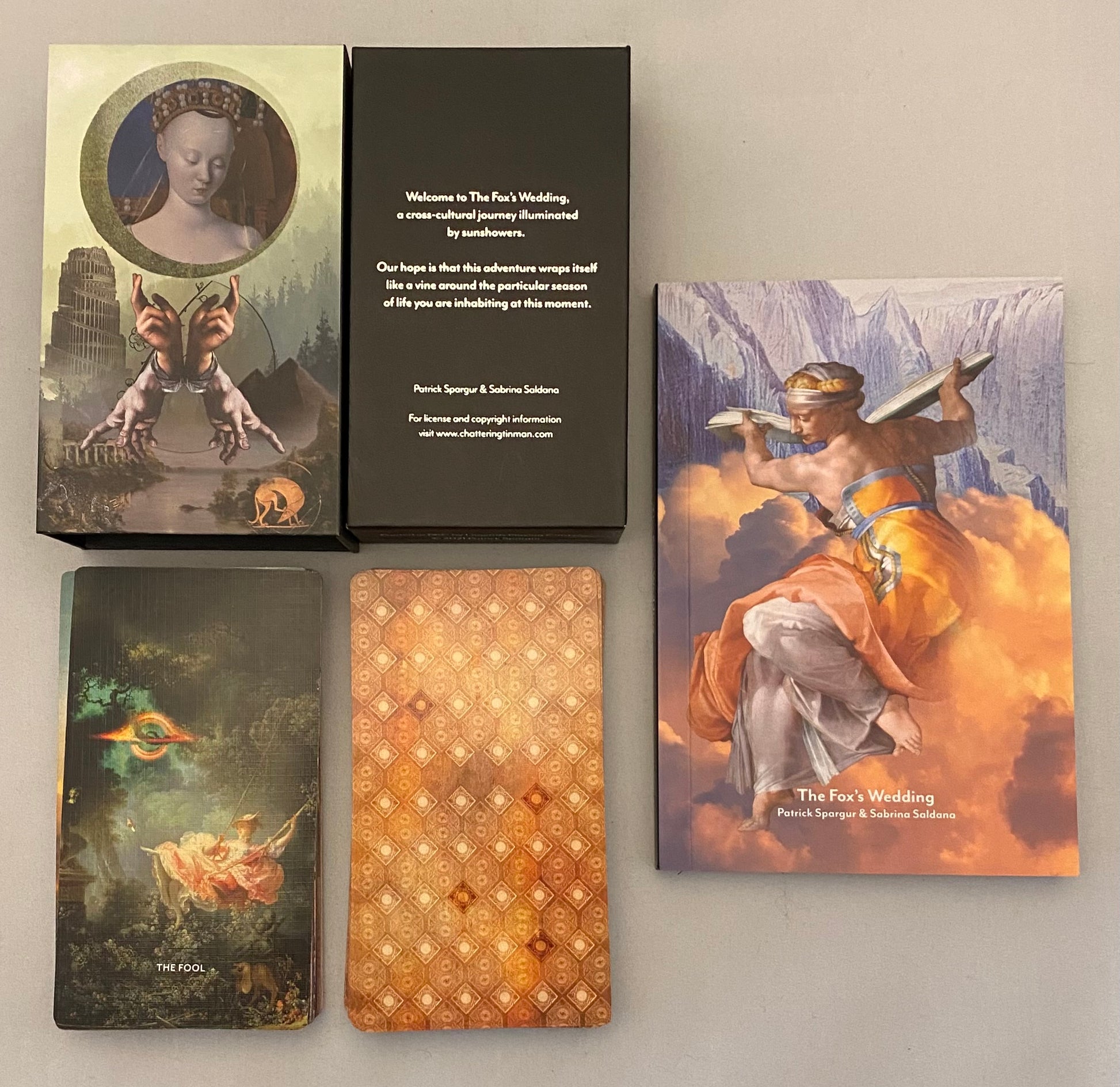 Collection of tarot cards, Fox's Wedding, and packaging on a neutral background