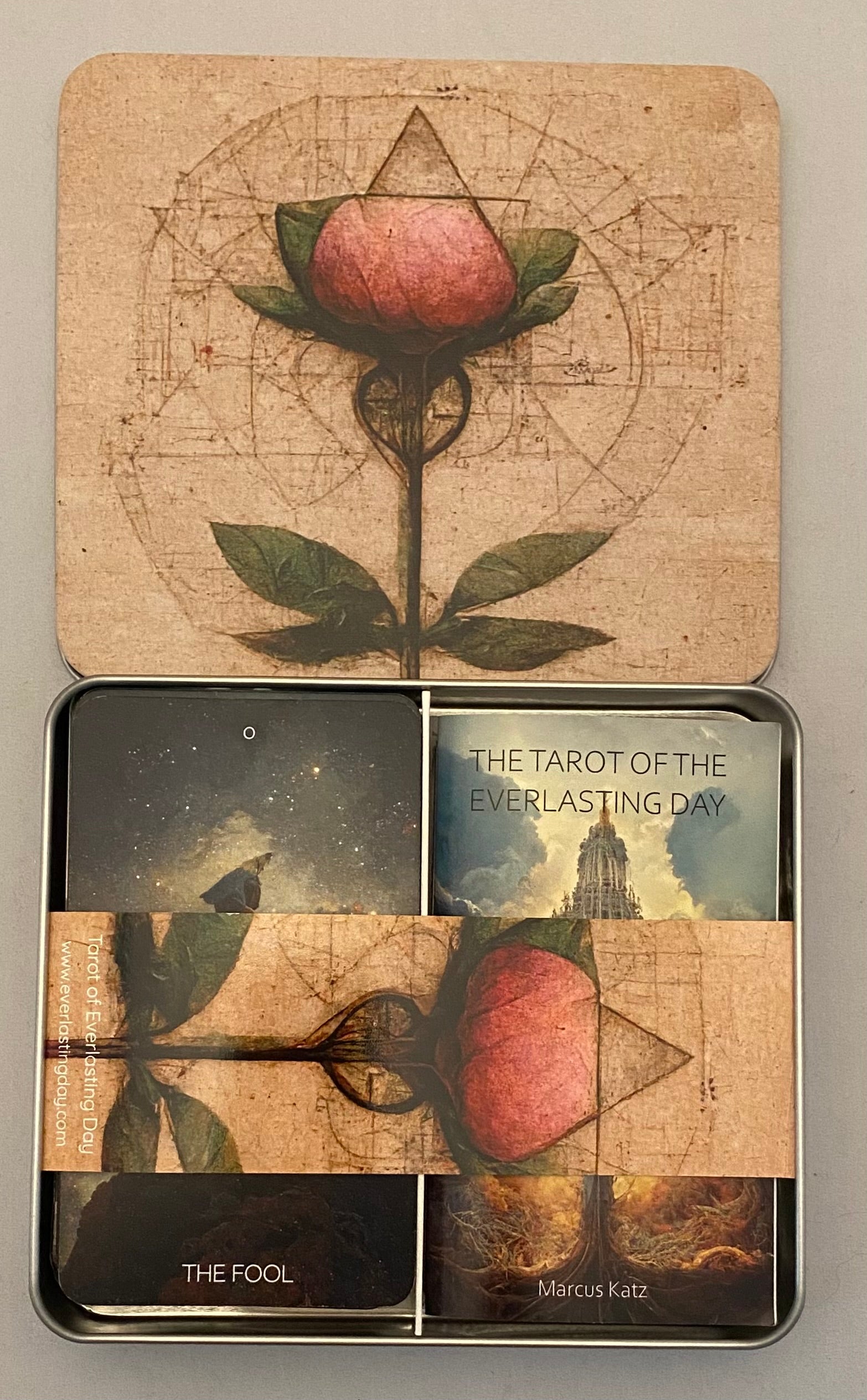 Tin box with tarot cards featuring a rose design on a beige background