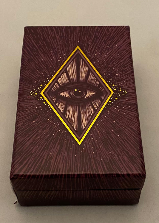 Decorative tarot box with eye design on a plain background