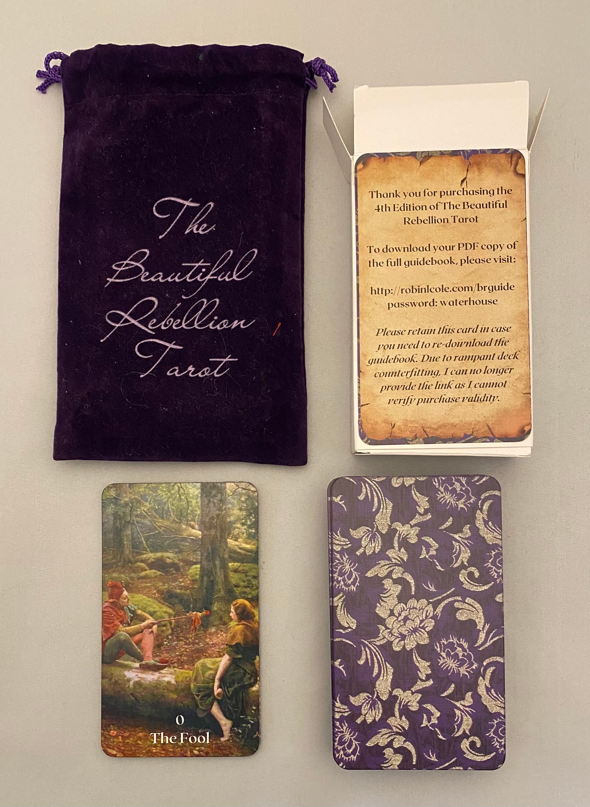 Tarot cards with a purple drawstring bag and card holder on a beige background