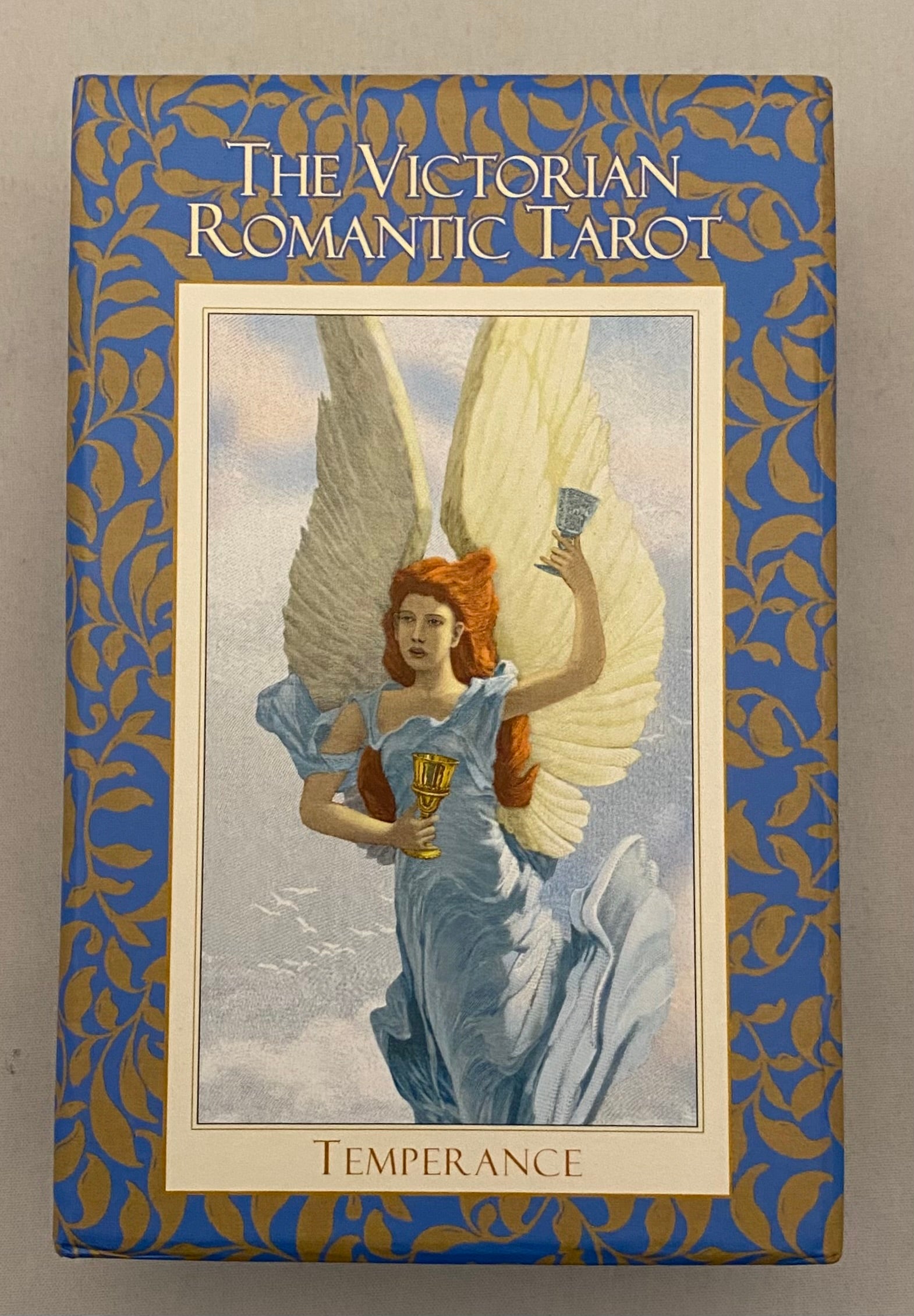 Box for 'The Victorian Romantic Tarot' with an angel illustration on a blue and gold background.
