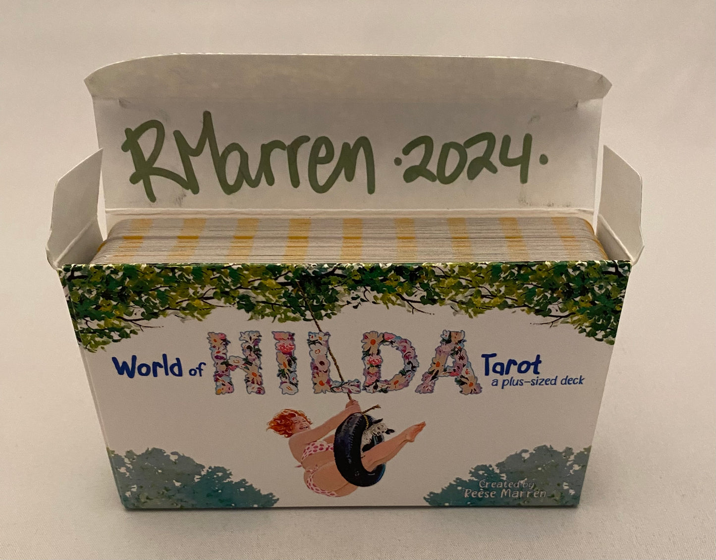 Box of 'World of Hilda' Tarot cards with illustrations and text on a white background