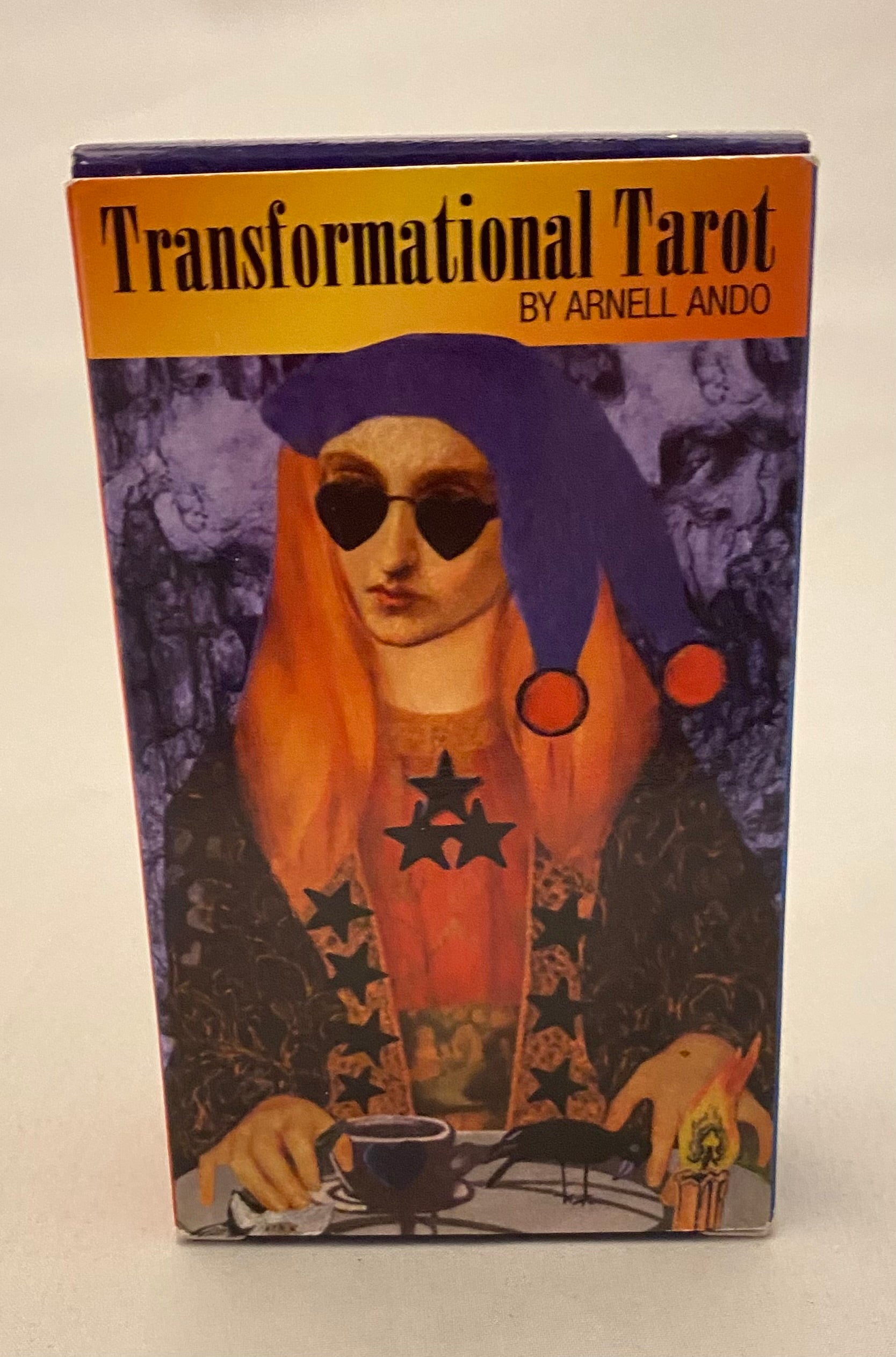 Box for 'Transformational Tarot' by Arnell Ando with a stylized illustration of a person wearing a purple hat and sunglasses.