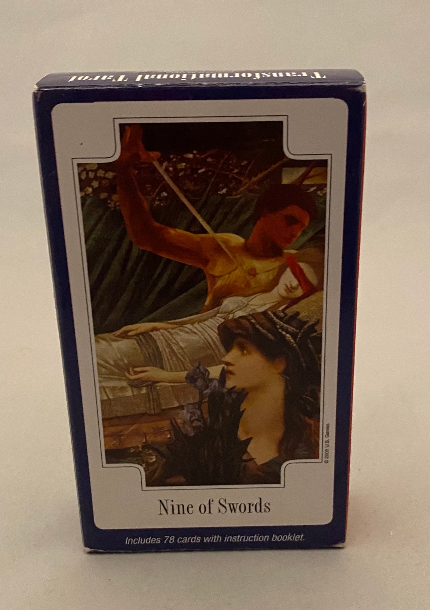 Card game packaging with illustration of two women and 'Nine of Swords' text on a white background