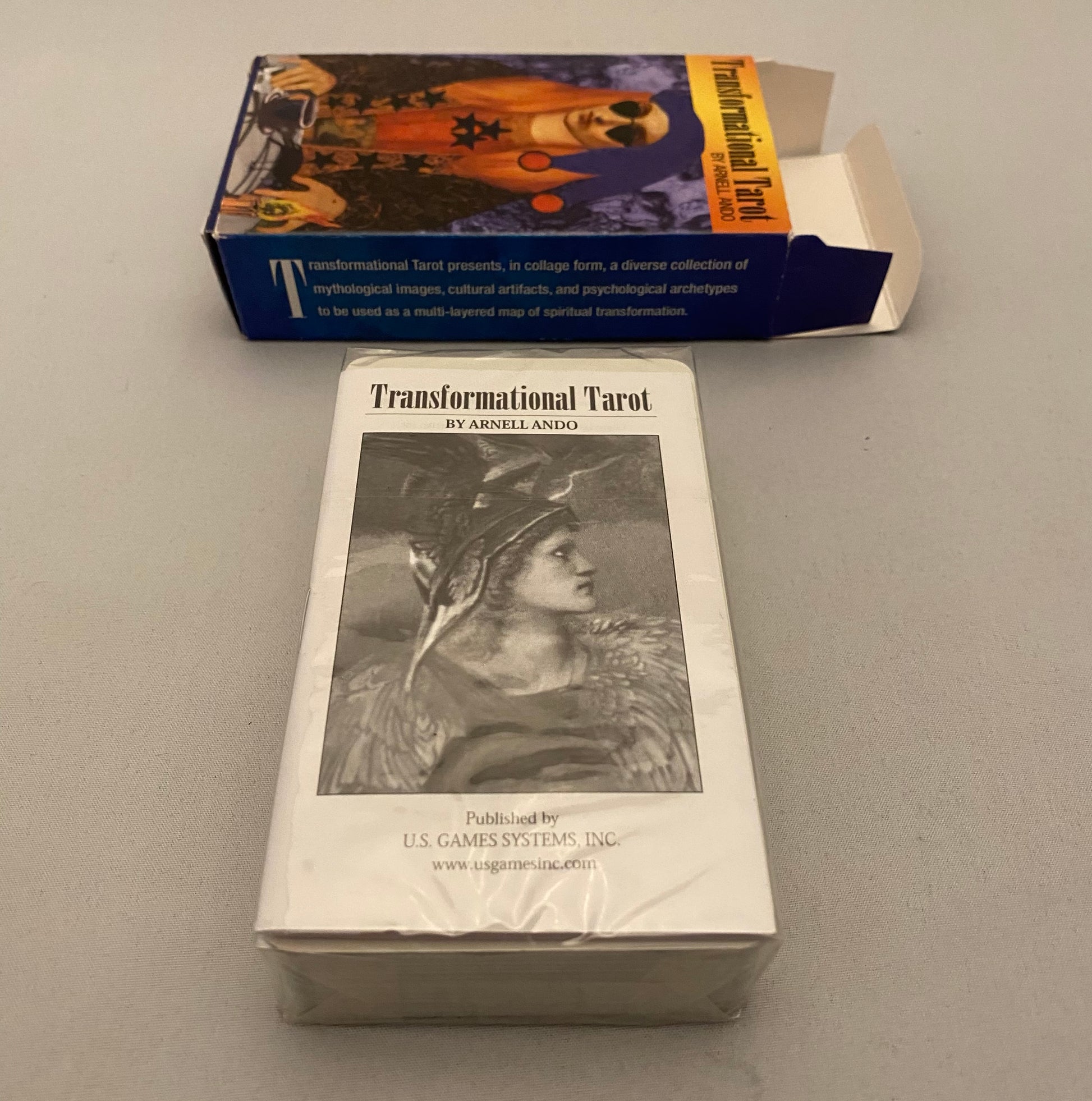 Transformational Tarot cards with packaging on a gray surface