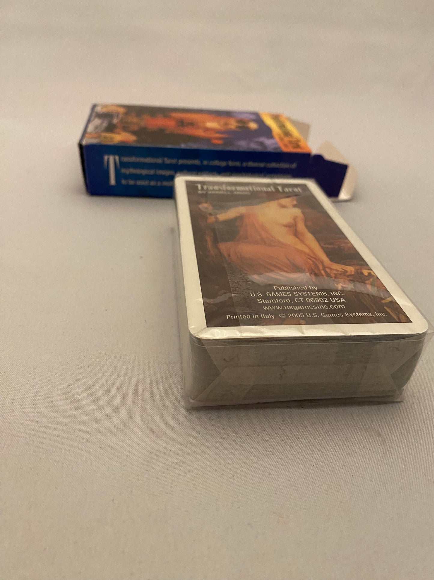 Tarot cards leaning against a light gray wall.