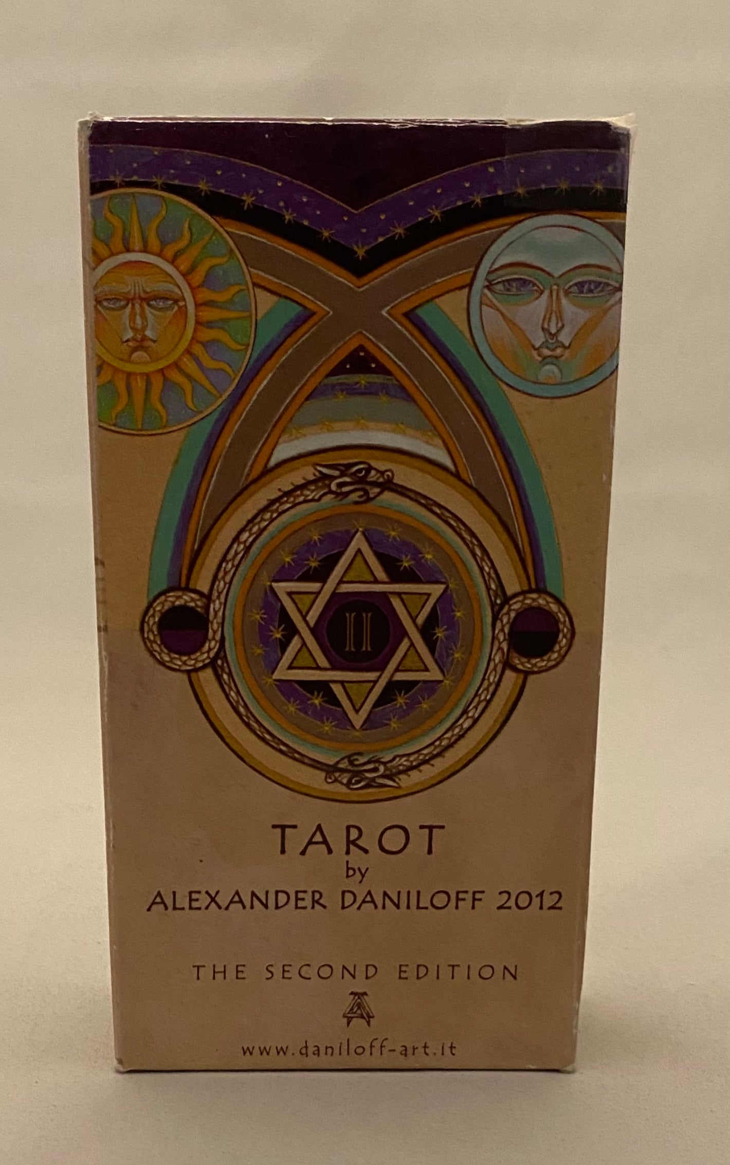 Box of Tarot cards by Alexander Daniloff with star and moon design on a beige background