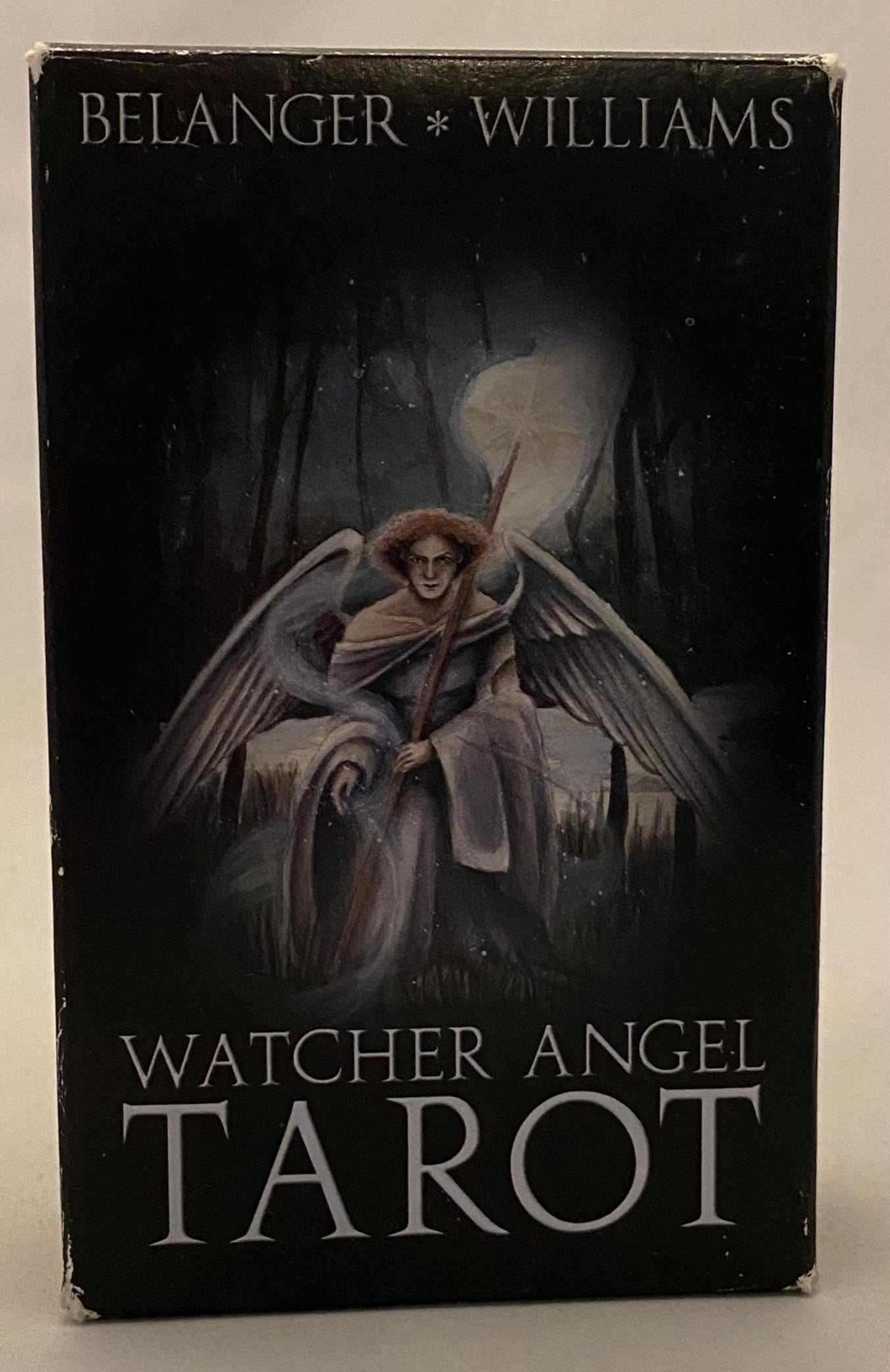 Tarot card box with an angel illustration on a dark background