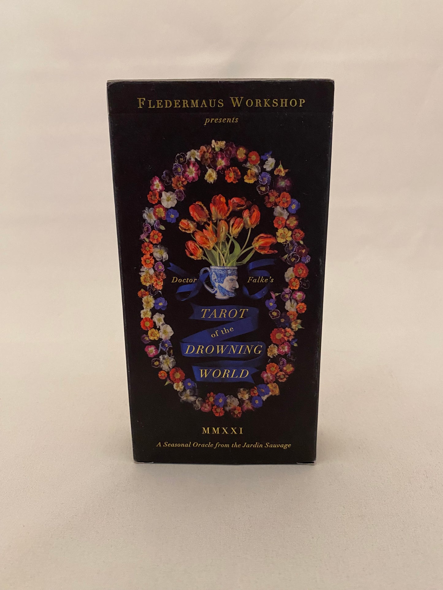 Tarot deck with colorful floral design and text on a beige background