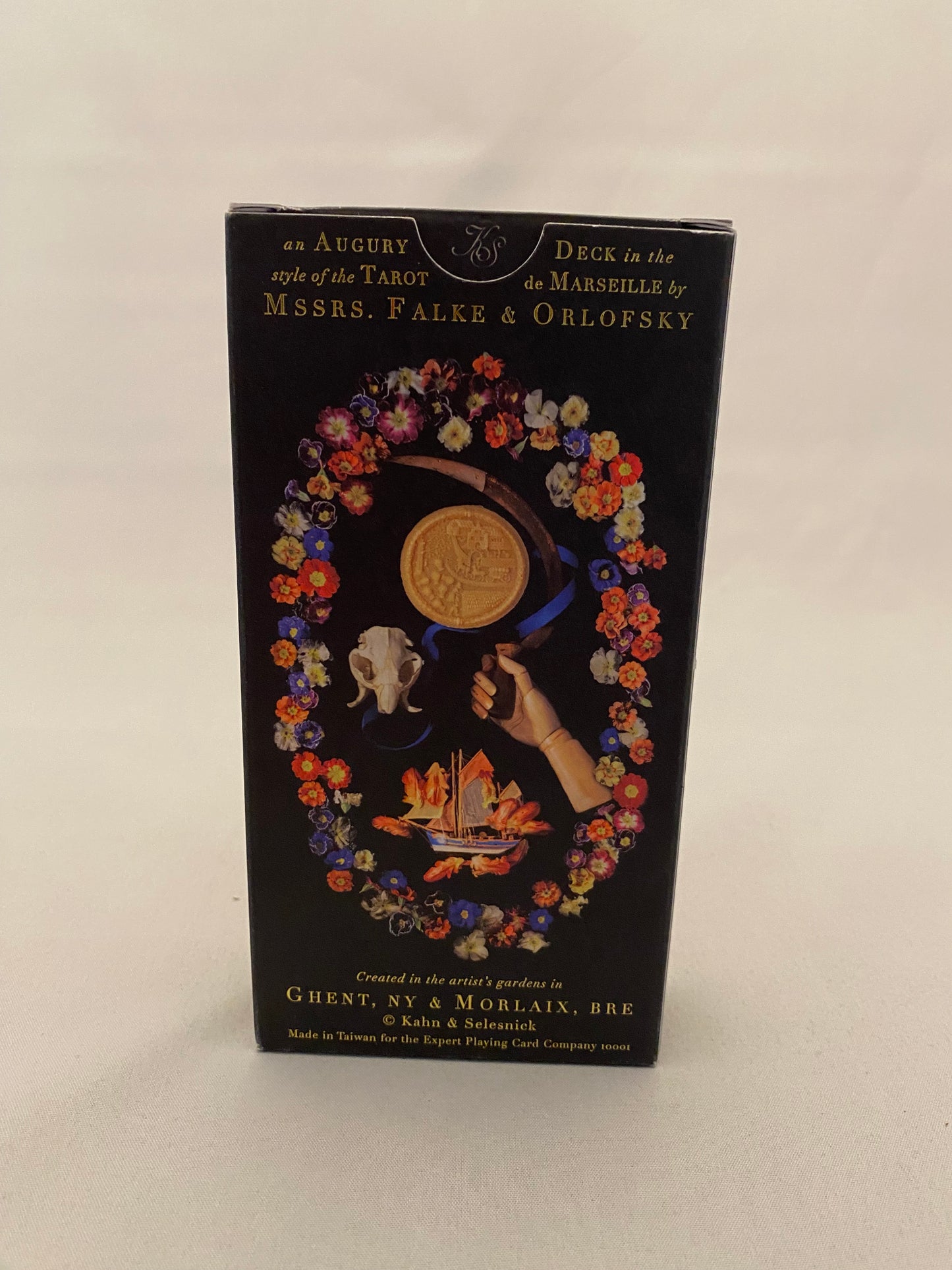 Decorative tarot deck box cover with floral design and text on a white background