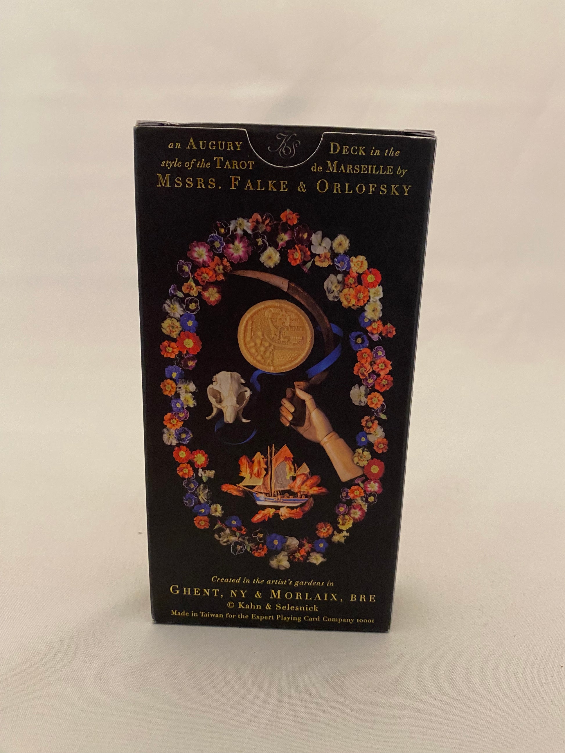 Decorative tarot deck box cover with floral design and text on a white background