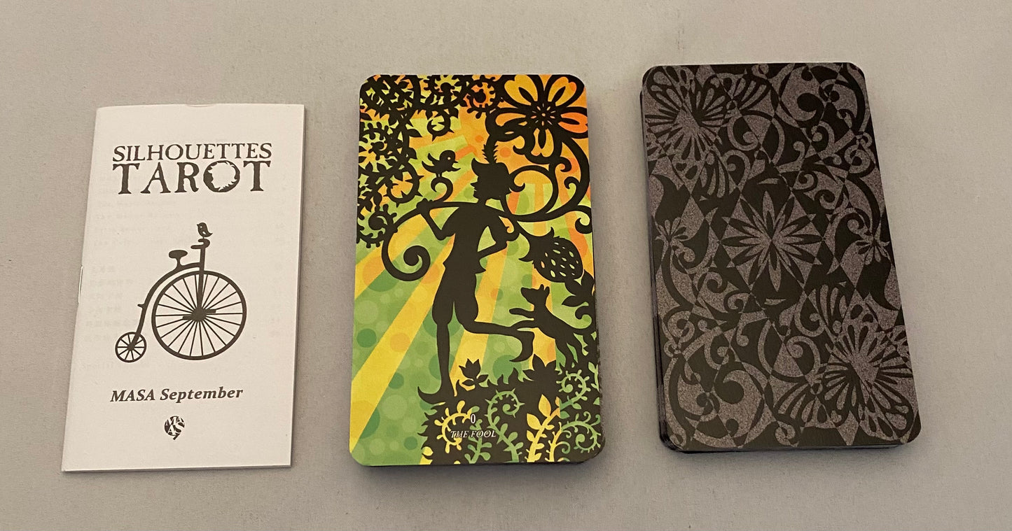 Three tarot card cases with different designs on a gray background