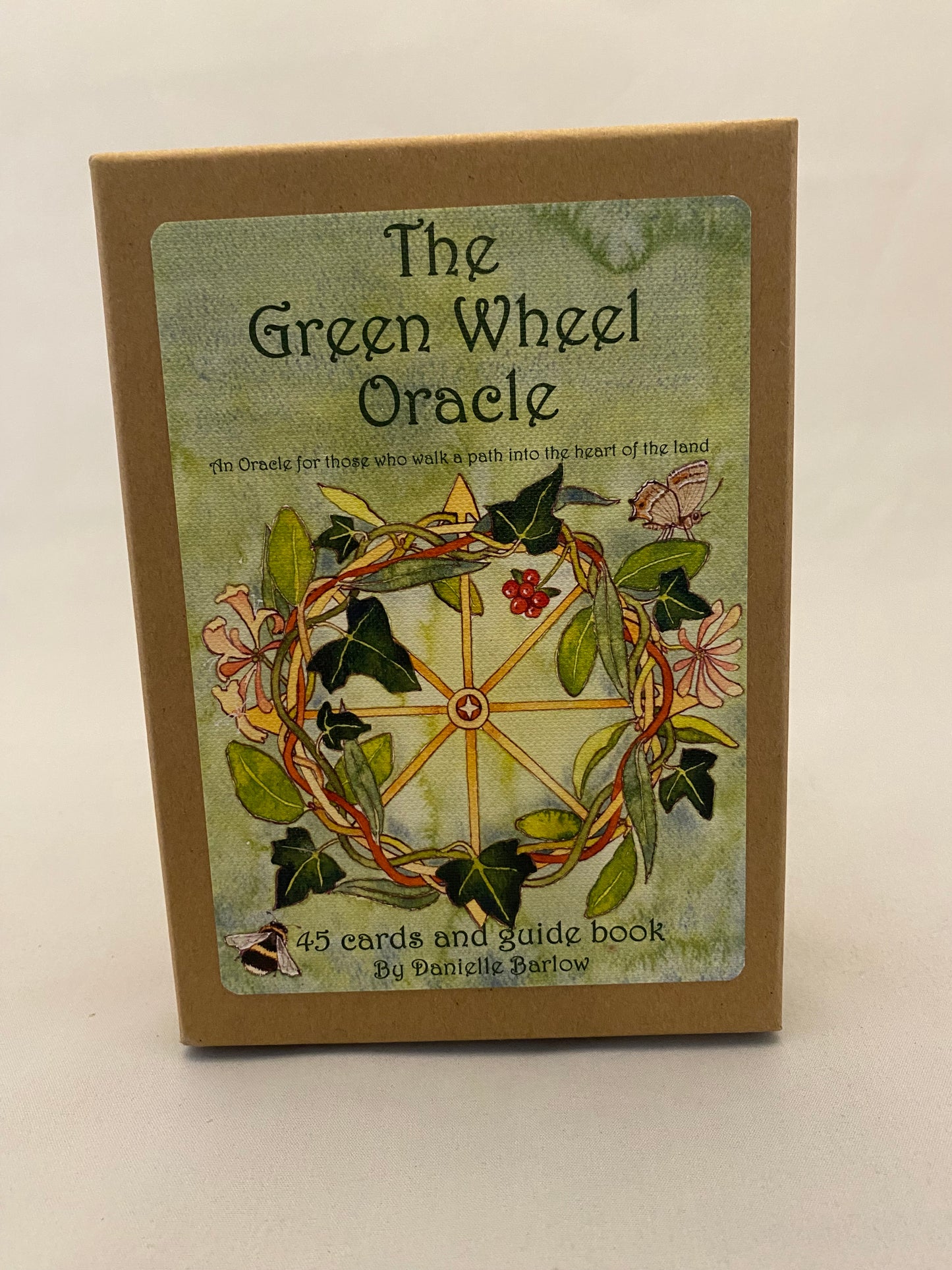 Card with 'The Green Wheel Oracle' design on a beige background