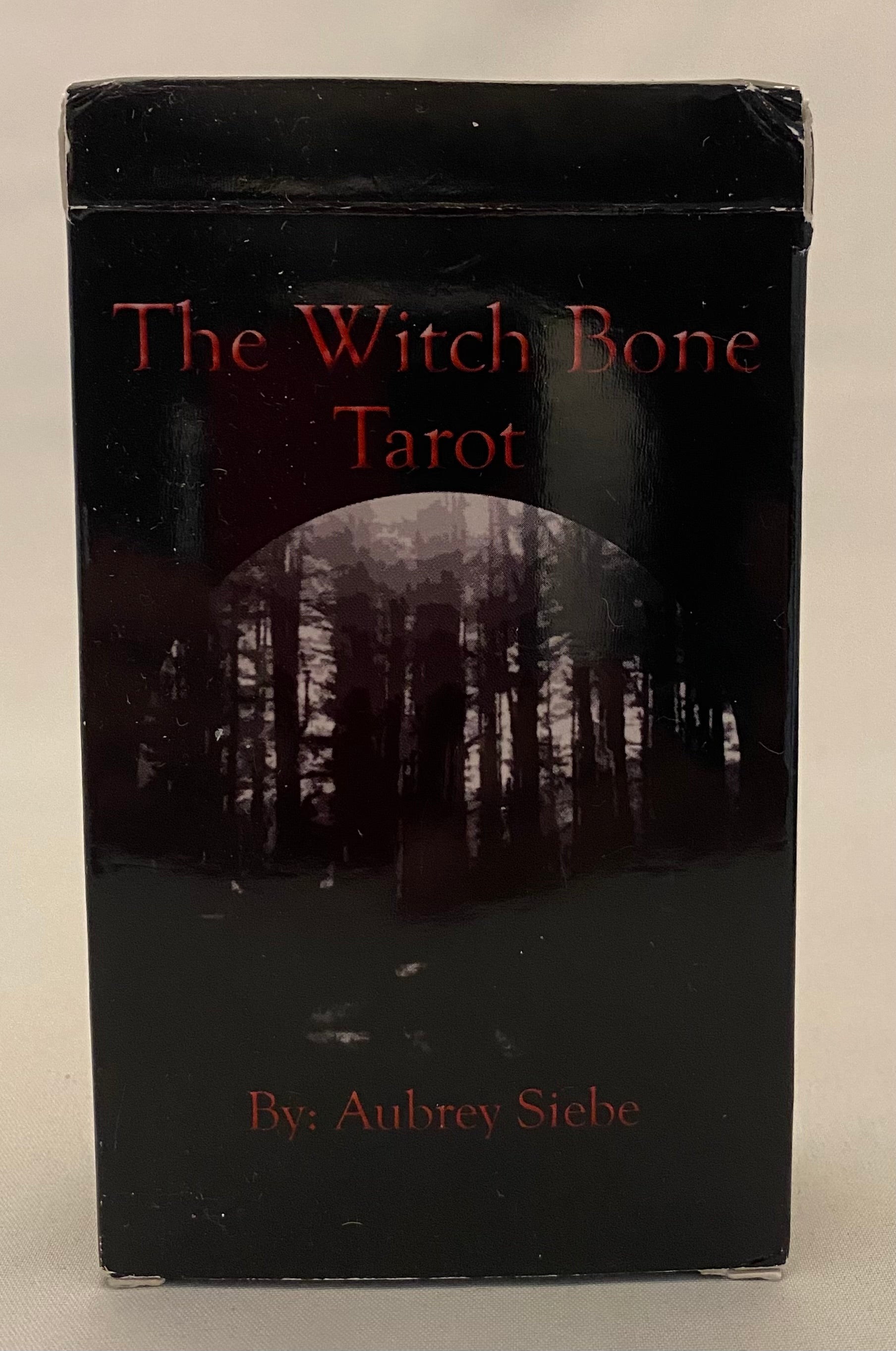 Black box of 'The Witch Bone Tarot' with a forest image on a white background